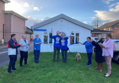Emma celebrates with staff after completing her mammoth walk for the Stars Appeal
