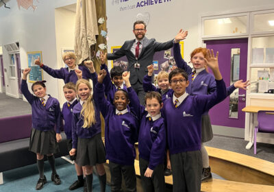 Headteacher, Ollie Martindale, celebrates with pupils at St Peters CoE Primary