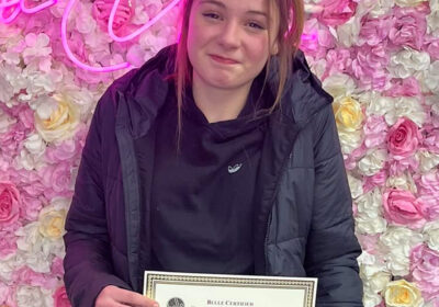 Phoebe Finnerty with her hair extension certificate