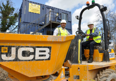 Braemar Lodge resident John Parfitt, 84, sits in the dumper track on the building site for the care home’s forthcoming extension, Stratford Court. With him is site manager, Paul Findlay