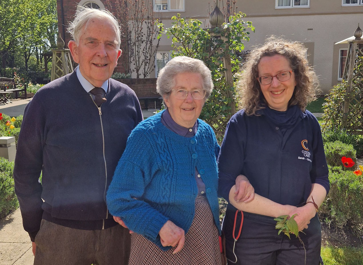 Enjoying a walk around the garden at the home are Bridge co-founder Gaye Ridout, centre, with her daughter Sarah Ridout, a Braemar Lodge gardener, and Gaye’s husband Tom
