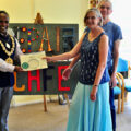 Atiqul Hoque presents a commemorative certificate and handcrafted badge to SRCs 1000th visitor, Christine Taylor with husband Richard looking on