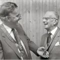 Pat Mullins presenting the first president, Stanley Beard, with his Badge of Office, which was donated by Rotary, in 1983