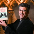 Dean of Salisbury, The Very Revd Nicholas Papadopulos, with a copy of his book, The Infernal Word. Picture: Finnbarr Webster