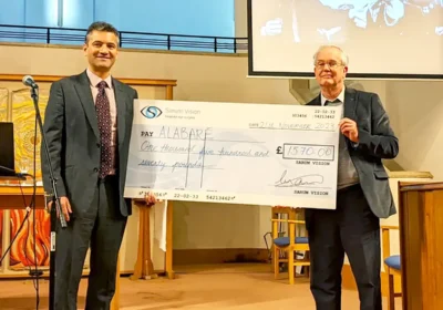 Naeem Haq presents Alabaré chairman, Malcolm Cassells with a cheque for £1,570