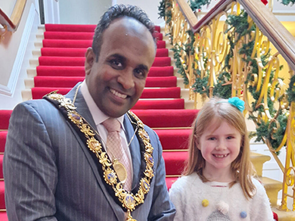 Cllr Hoque and Martha, winner of the Christmas card competition.