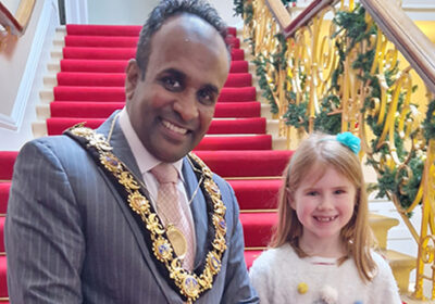 Cllr Hoque and Martha, winner of the Christmas card competition.