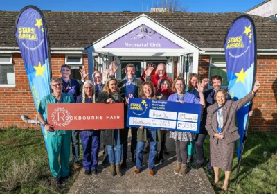 Members of the Rockbourne Fair Committee present the donation to Stars Appeal President, the Earl of Pembroke, and Stars Appeal Hospital Ambassadors outside the Neonatal Unit at Salisbury District Hospital. Picture: Spencer Mulholland