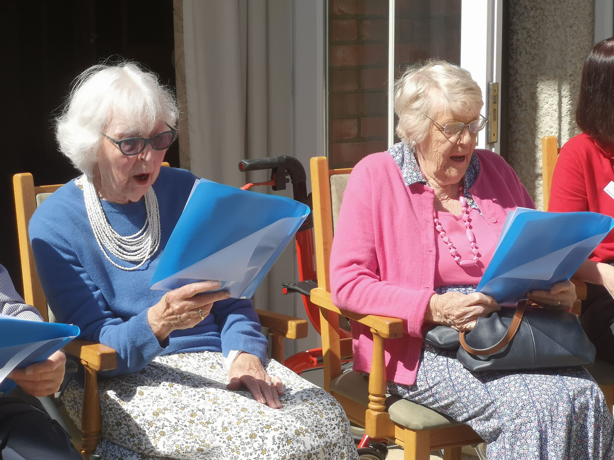 Residents Joan Hills, left, and Sheila Nell in fine voice as members of the Braemar Singing Group who performed at the garden party Picture: Colten Care