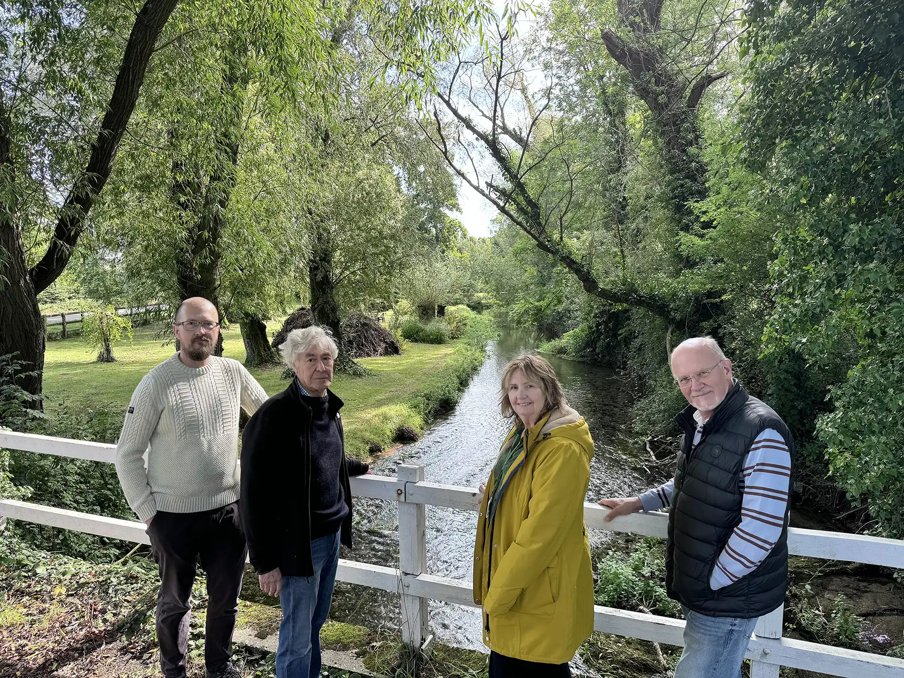 Broad Chalke Community Land Trust chairman Dan Richter, left, board member Ian Walkden  and treasurer Tom Hitchings with White Horse Housing Association Operations Director Belinda Eastland at the River Ebble in the village