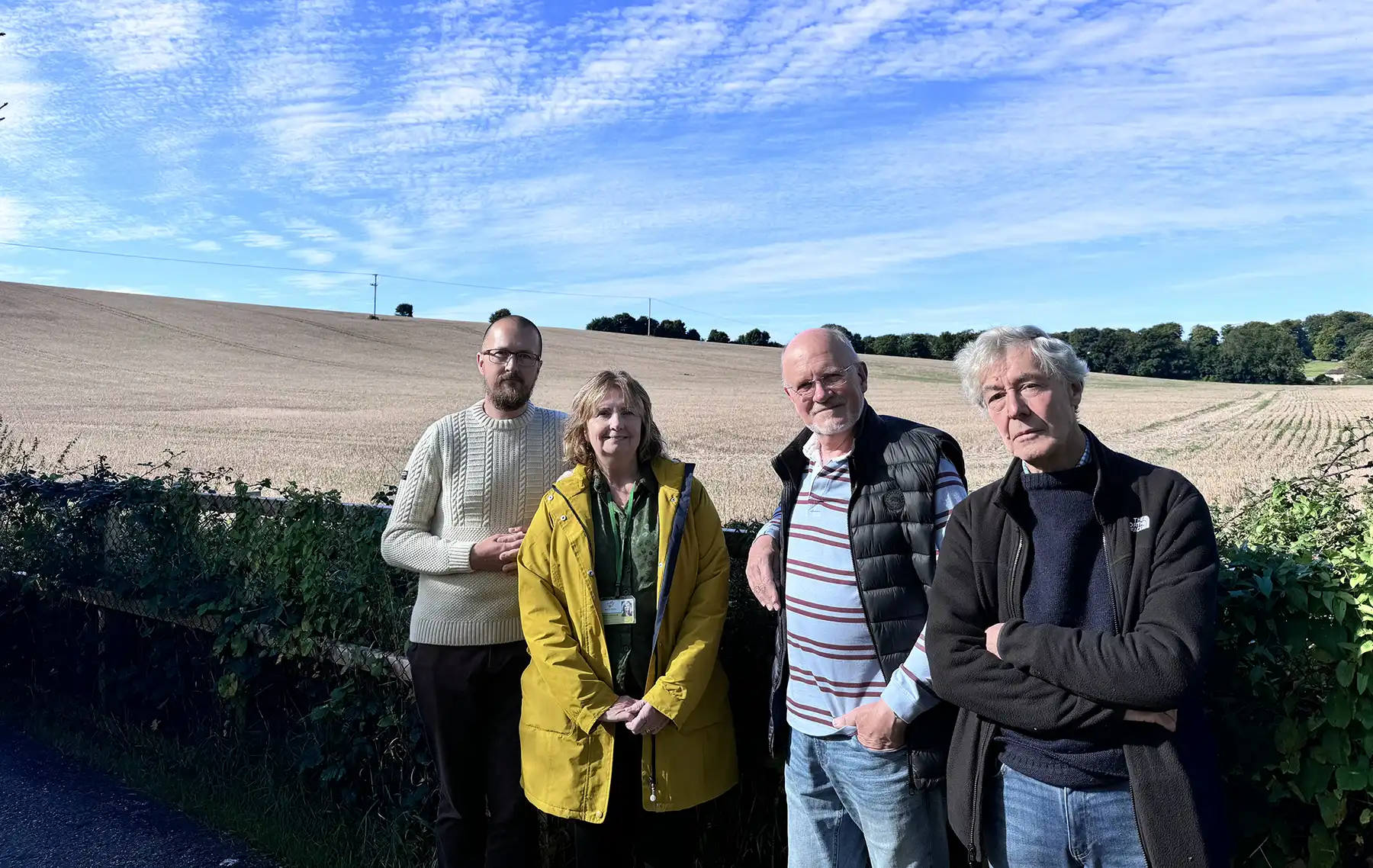 Broad Chalke Community Land Trust chairman Dan Richter, left, treasurer Tom Hitchings and board member Ian Walkden with White Horse Housing Association Operations Director Belinda Eastland at the site in the village where six new affordable homes are being blocked by Nutrient Neutrality regulations