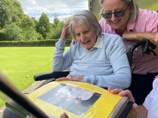 Sylvia looking at old photos Picture: Wilton Place/ Barchester