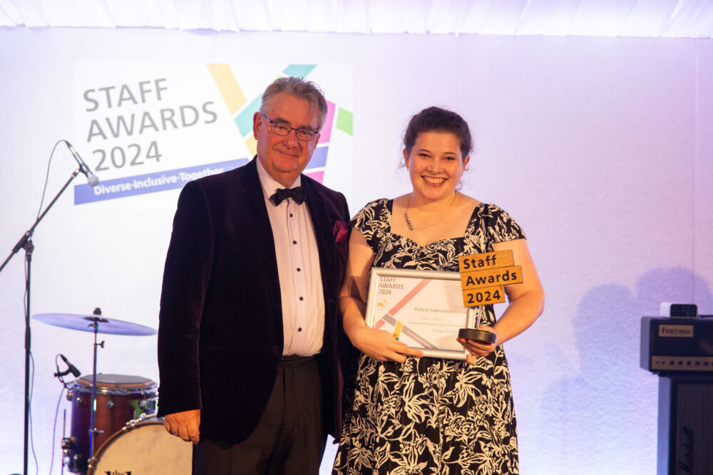 Speech therapist Lizzie Goodyear being presented with the Patient Experience Award by Stephen Oxley, Stars Appeal fundraising chairman at the 2024 Staff Awards ceremony Picture: Salisbury NHS Foundation Trust