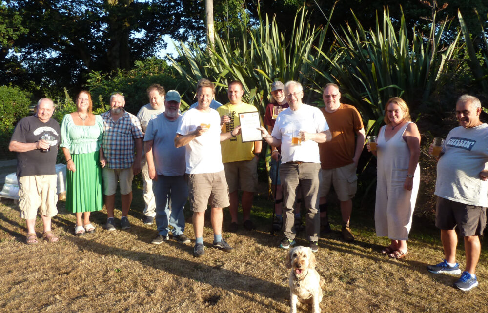 Brewer Paul Bartlett (left) receives his Beer of the Festival award certificate from Andrew Hesketh of Salisbury CAMRA At the front is Sunny, the dog who was the partial inspiration for the beer’s name. Picture :Salisbury CAMRA