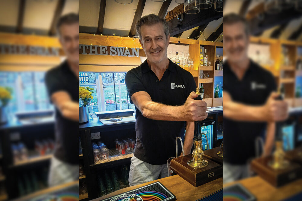 Rupert Everett serving behind the bar of The Swan wearing his CAMRA t-shirt Picture: Salisbury CAMRA