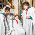 Senior choristers gently bumping Sebastian on the bumping stone Picture: Max Willcock BNPS