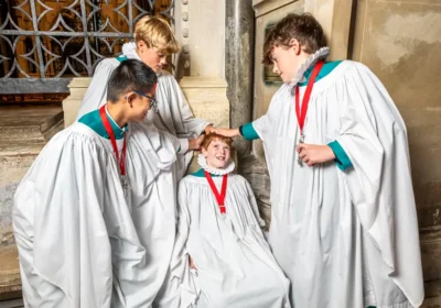 Senior choristers gently bumping Sebastian on the bumping stone Picture: Max Willcock BNPS