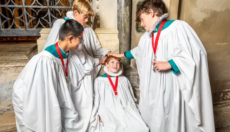 Senior choristers gently bumping Sebastian on the bumping stone Picture: Max Willcock BNPS
