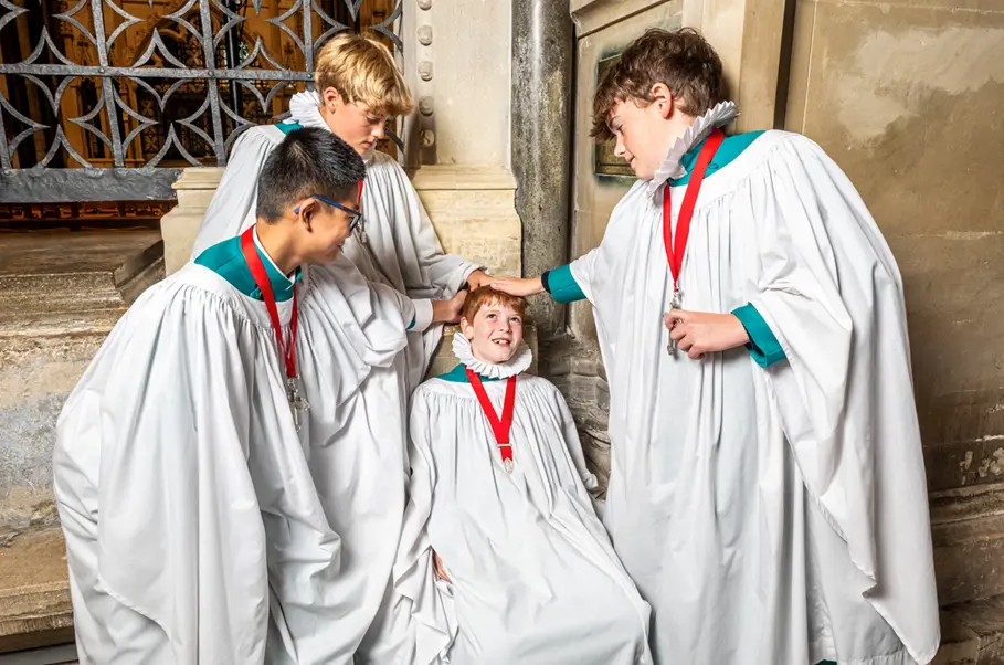 Senior choristers gently bumping Sebastian on the bumping stone Picture: Max Willcock BNPS