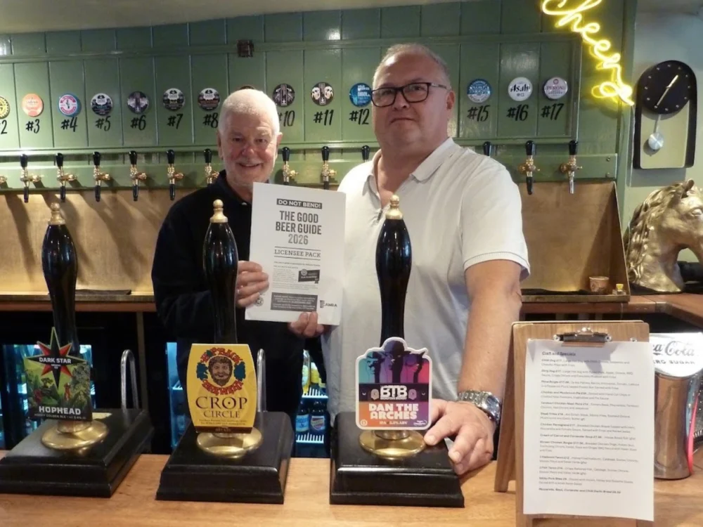 Keith Foster, Good Beer Guide co-ordinator for Salisbury & South Wilts CAMRA, presenting Coach & Horses landlord Chris Meaker with his certificate Picture: Salisbury CAMRA
