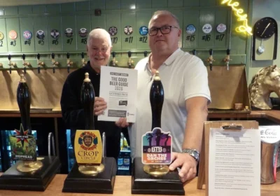 Keith Foster, Good Beer Guide co-ordinator for Salisbury & South Wilts CAMRA, presenting Coach & Horses landlord Chris Meaker with his certificate Picture: Salisbury CAMRA