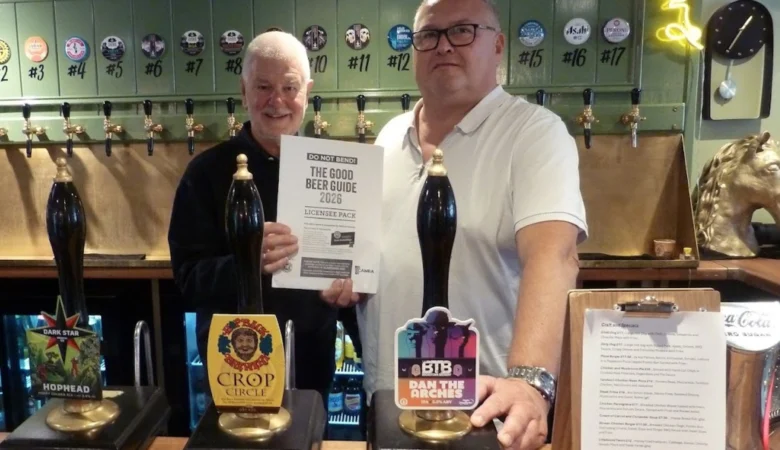 Keith Foster, Good Beer Guide co-ordinator for Salisbury & South Wilts CAMRA, presenting Coach & Horses landlord Chris Meaker with his certificate Picture: Salisbury CAMRA