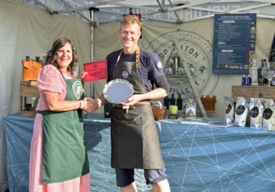 Hugh Anderson from Downton Distillery being presented with the award by Natasha Dochniak of Hampshire Fare Picture: Downton Distillery