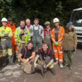 A suitably muddy Ruby with her rescuers Picture: Wiltshire Council