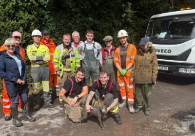 A suitably muddy Ruby with her rescuers Picture: Wiltshire Council