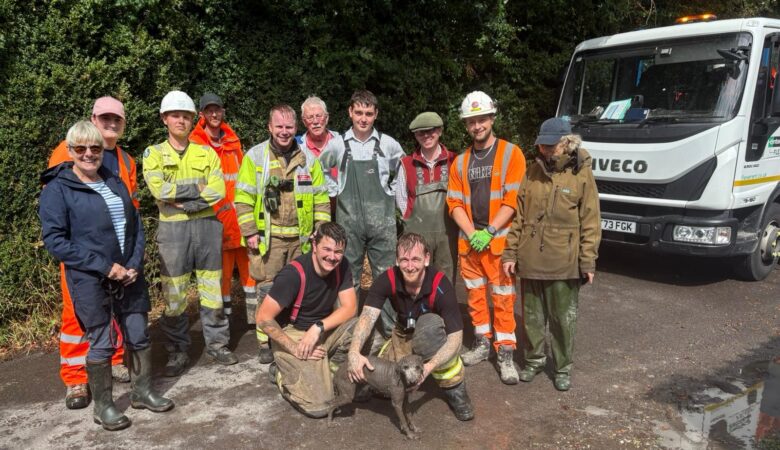 A suitably muddy Ruby with her rescuers Picture: Wiltshire Council
