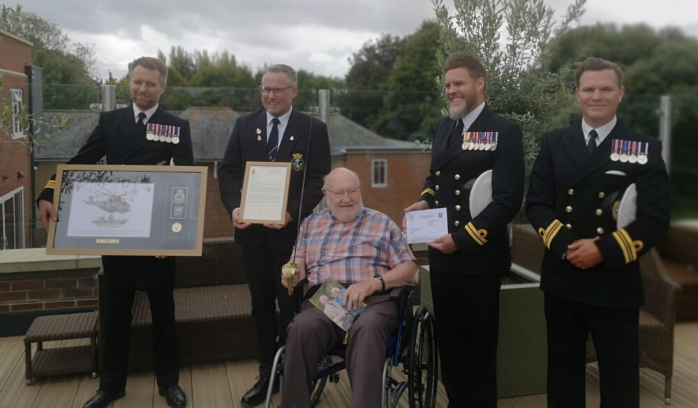 D-Day veteran Commander Douglas Parish celebrates his 100th birthday at Braemar Lodge care home in Salisbury in the company of uniformed Royal Navy representatives Picture: Braemar Lodge