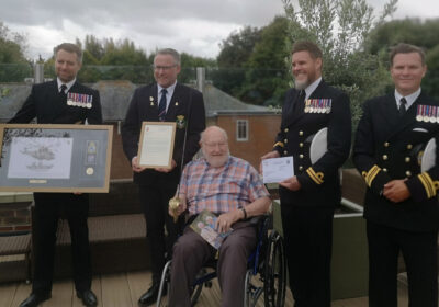 D-Day veteran Commander Douglas Parish celebrates his 100th birthday at Braemar Lodge care home in Salisbury in the company of uniformed Royal Navy representatives Picture: Braemar Lodge