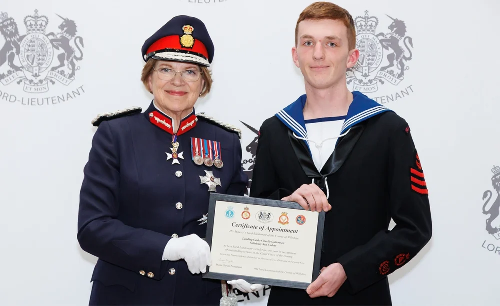 Charlie being presented with a certificate honourin his new role by Dame Sarah Troughton Picture: Salisbury Sea Cadets