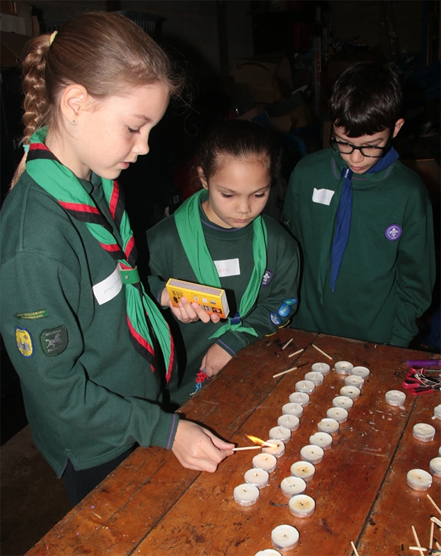 Cubs lighting t-lights with one match Picture: Mark Warner