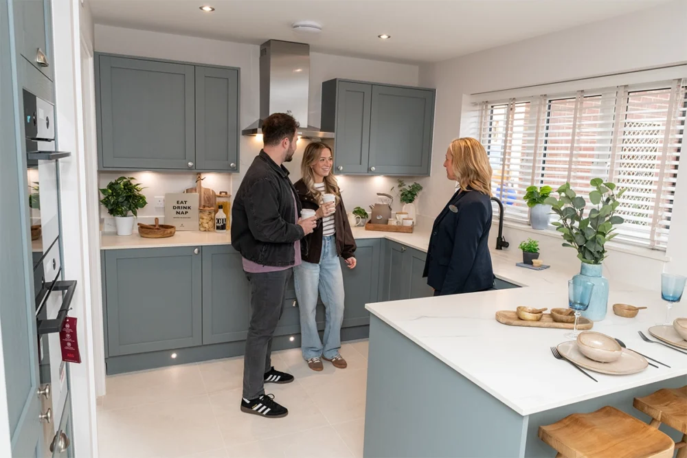 Bellway sales advisor Verity Skene, right, with Sales Manager Emily Putnam and George Putnam in the kitchen of the Scrivener showhome Picture: Bellway