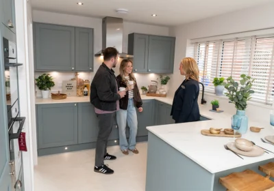 Bellway sales advisor Verity Skene, right, with Sales Manager Emily Putnam and George Putnam in the kitchen of the Scrivener showhome Picture: Bellway