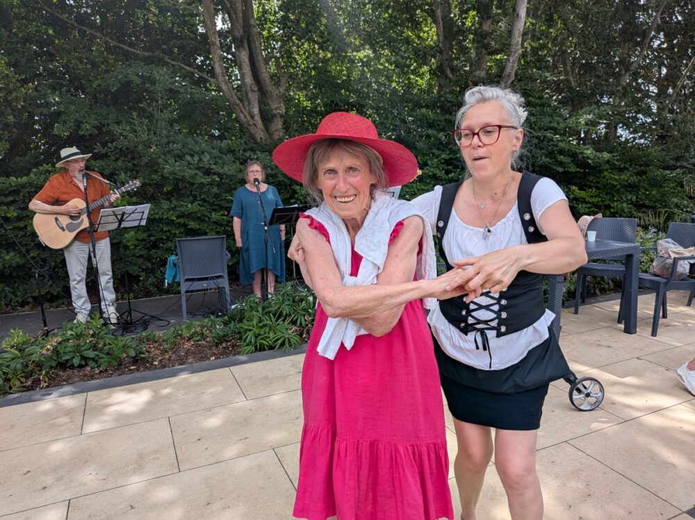 Braemar Lodge Waitress Ildiko Fuves, right, and resident Jackie Jilbert enjoy a dance to live music from folk band Maerefolk