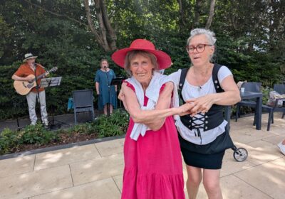 Braemar Lodge Waitress Ildiko Fuves, right, and resident Jackie Jilbert enjoy a dance to live music from folk band Maerefolk