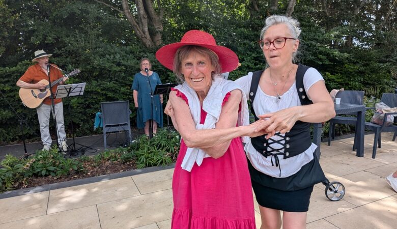 Braemar Lodge Waitress Ildiko Fuves, right, and resident Jackie Jilbert enjoy a dance to live music from folk band Maerefolk