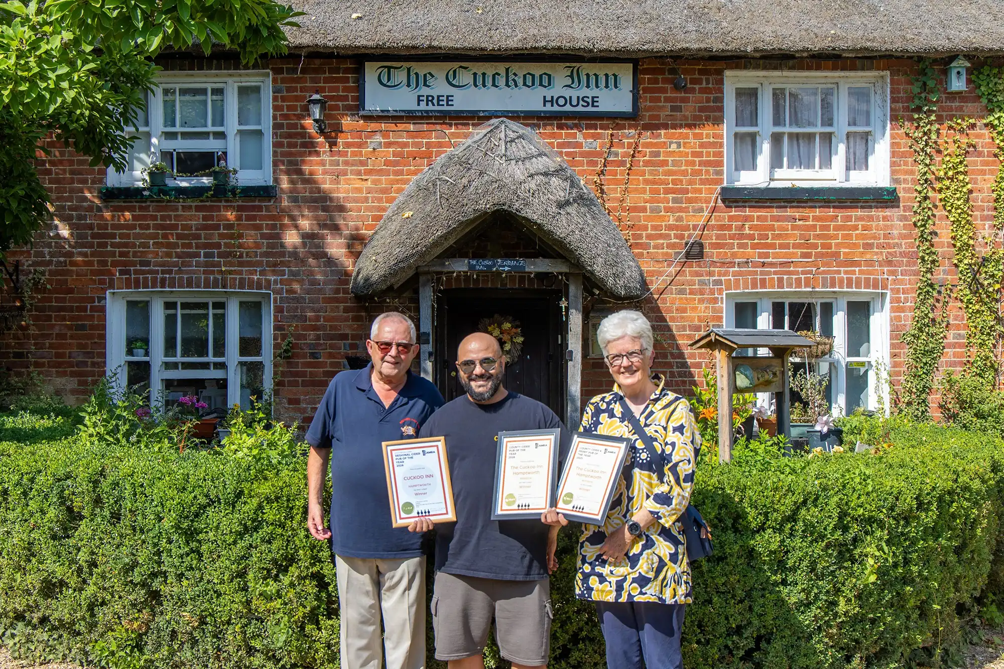 Cuckoo Inn landlord Nik Amplianitis, centre, receives the award from CAMRA Salisbury & South Wiltshire branch regional director Norman Clinnick, and cider champion Jane Foster