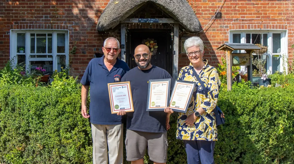 Cuckoo Inn landlord Nik Amplianitis, centre, receives the award from CAMRA Salisbury & South Wiltshire branch regional director Norman Clinnick, and cider champion Jane Foster