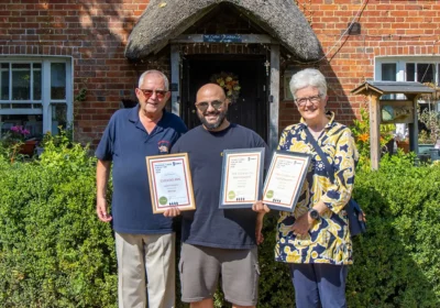 Cuckoo Inn landlord Nik Amplianitis, centre, receives the award from CAMRA Salisbury & South Wiltshire branch regional director Norman Clinnick, and cider champion Jane Foster