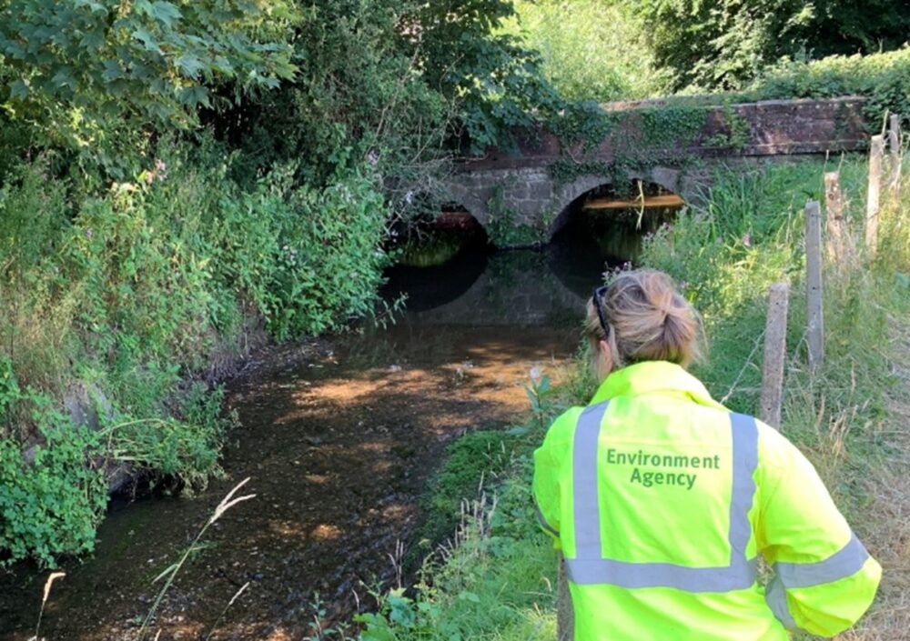An Environment Agency officer checks water levels