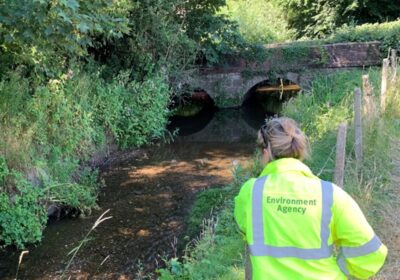 An Environment Agency officer checks water levels