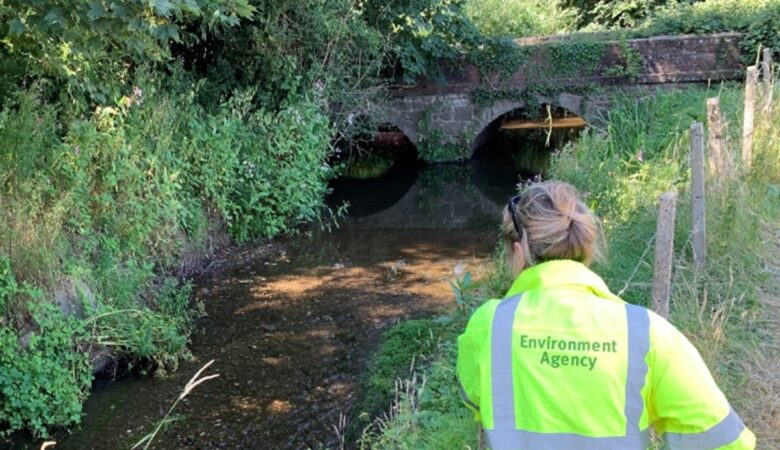 An Environment Agency officer checks water levels
