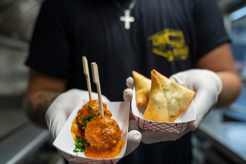 Person wearing gloves holds takeaway food