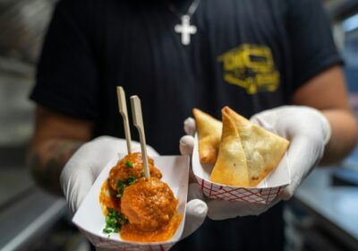 Person wearing gloves holds takeaway food