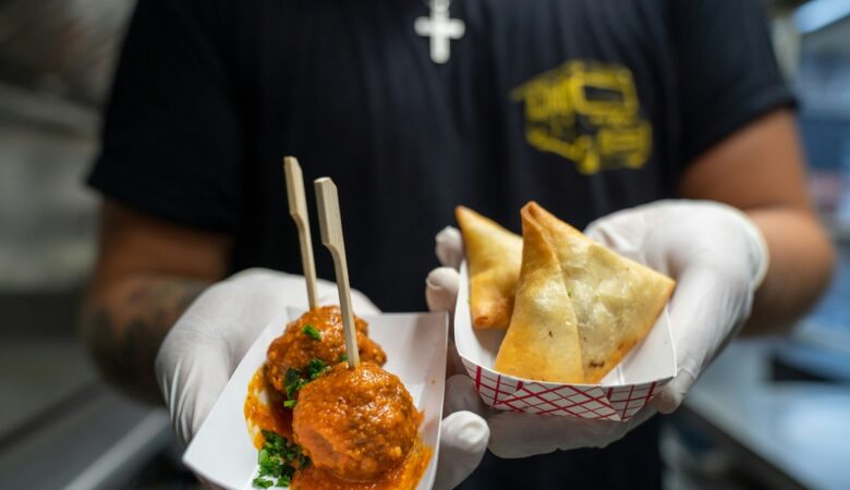 Person wearing gloves holds takeaway food