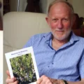 John Cox with his book, Memories for Rosemary